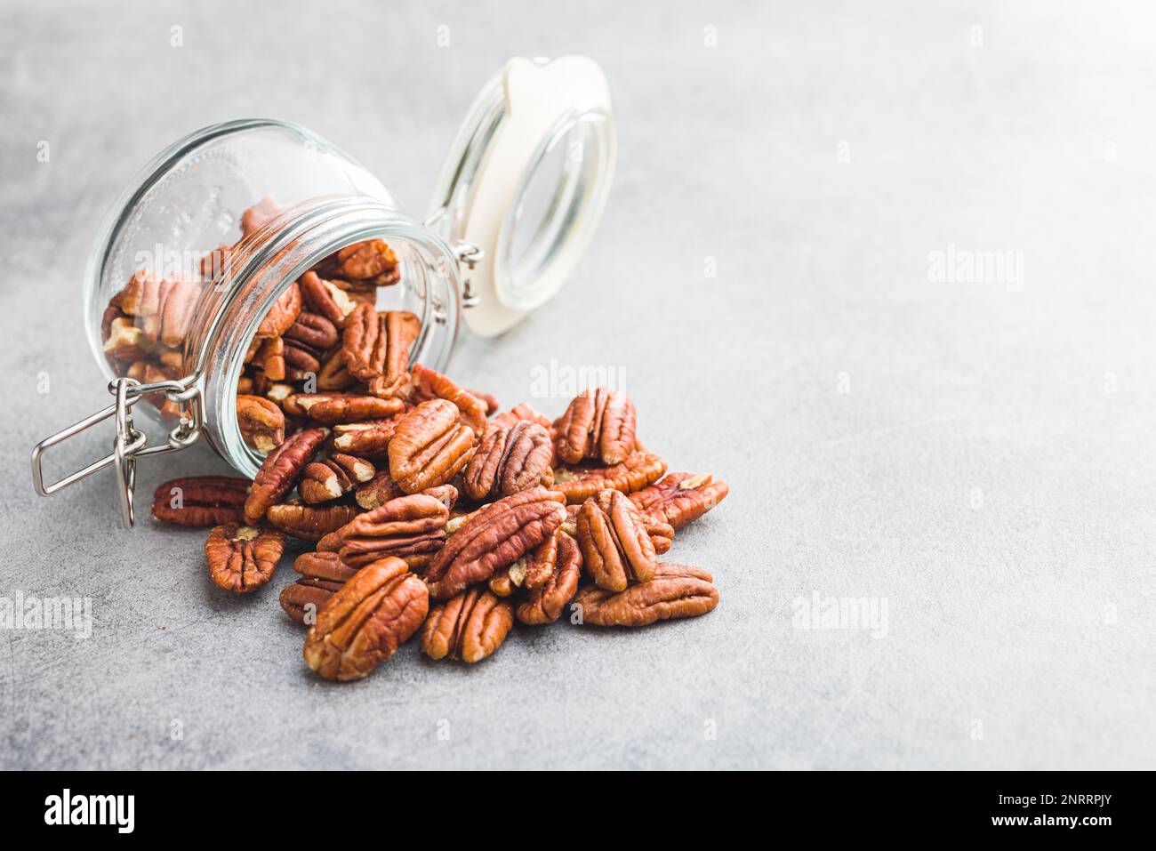 Peeled pecan nuts in jar on the kitchen table. Stock Photo