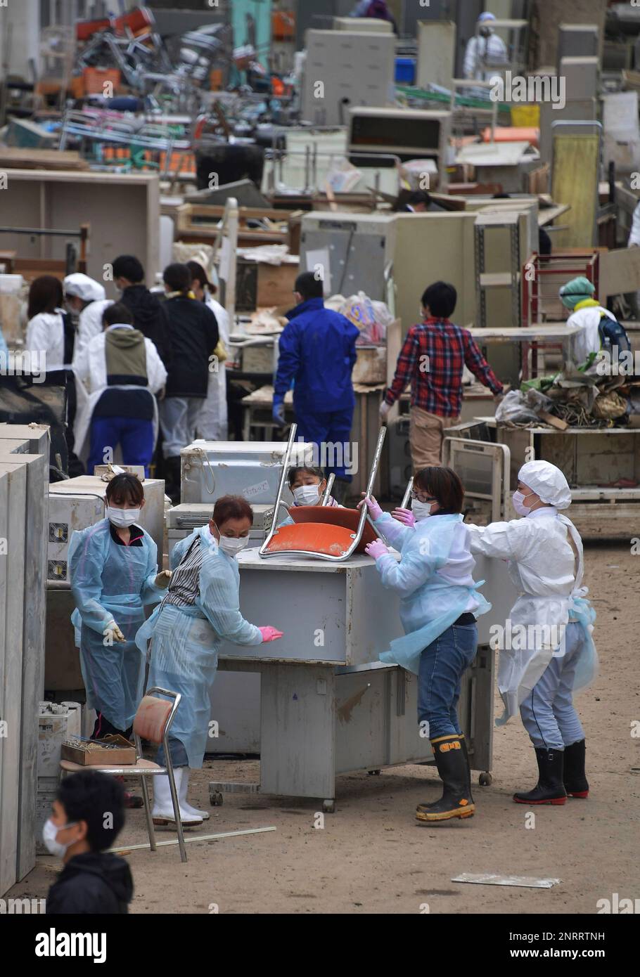 Hospital staffs clean up chairs, beds and equipment which are dirty with muddy water of flood in Motomiya City, Fukushima Prefecture on October 18, 2019. Typhoon Hagibis, a powerful super typhoon, made a landfall in Japan on Oct. 12th, and caused huge damage in wide area of Japan. ( The Yomiuri Shimbun via AP Images ) Stock Photo