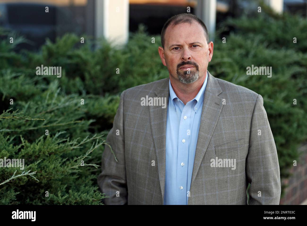 Lubbock Police detective Brandon Price poses for a photo outside the department headquarters