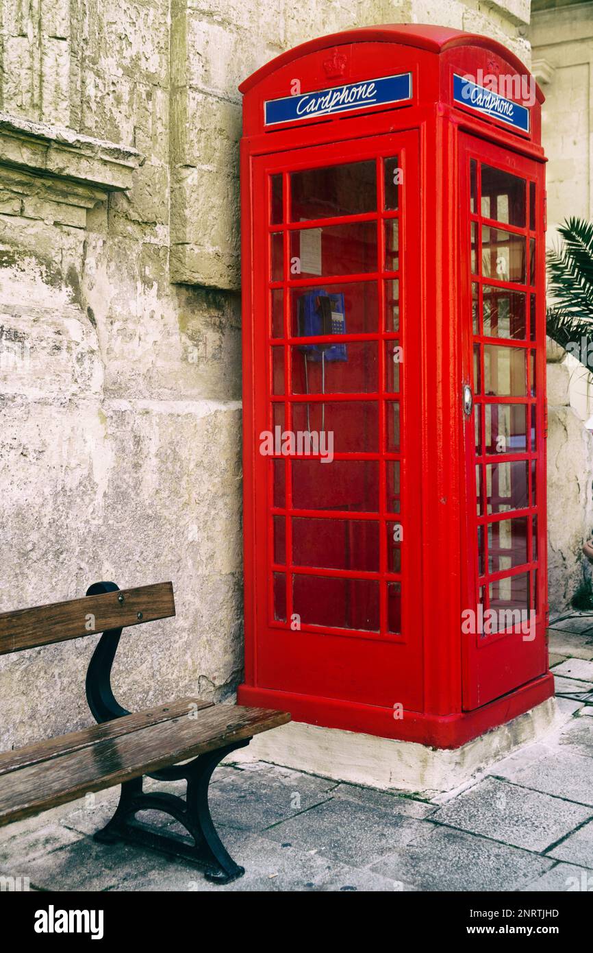 An iconic red telephone box in maltese town Mdina. Malta English