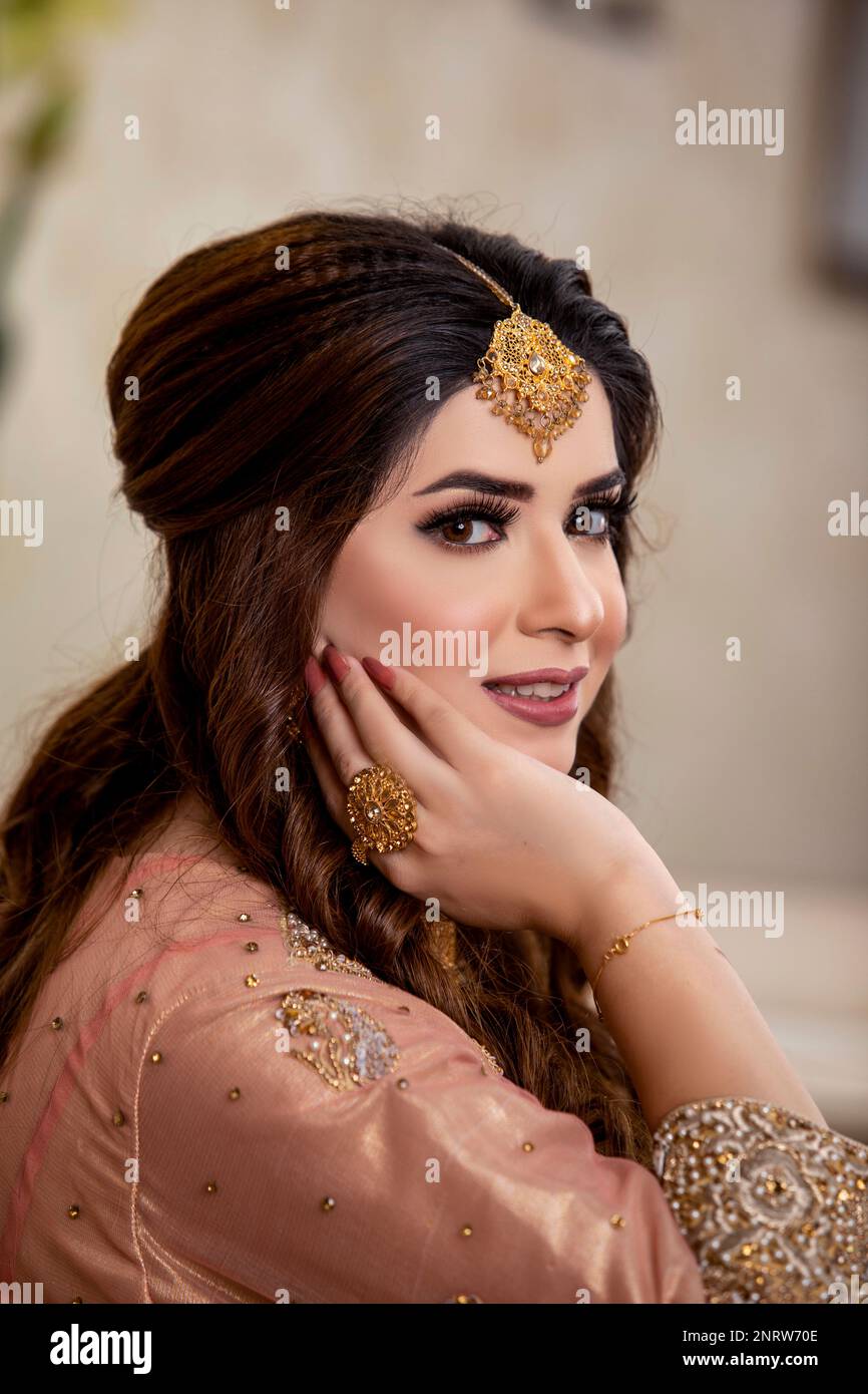 Indian bride dressed in traditional wedding clothes Stock Photo
