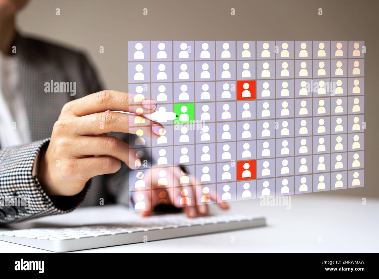 Human resources manager working with digital employee database marking high and low potential employees. Stock Photo
