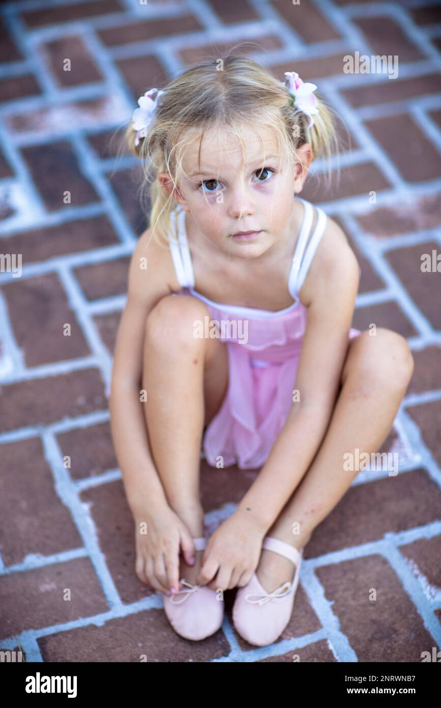 Little girl putting on ballet slippers Stock Photo Alamy