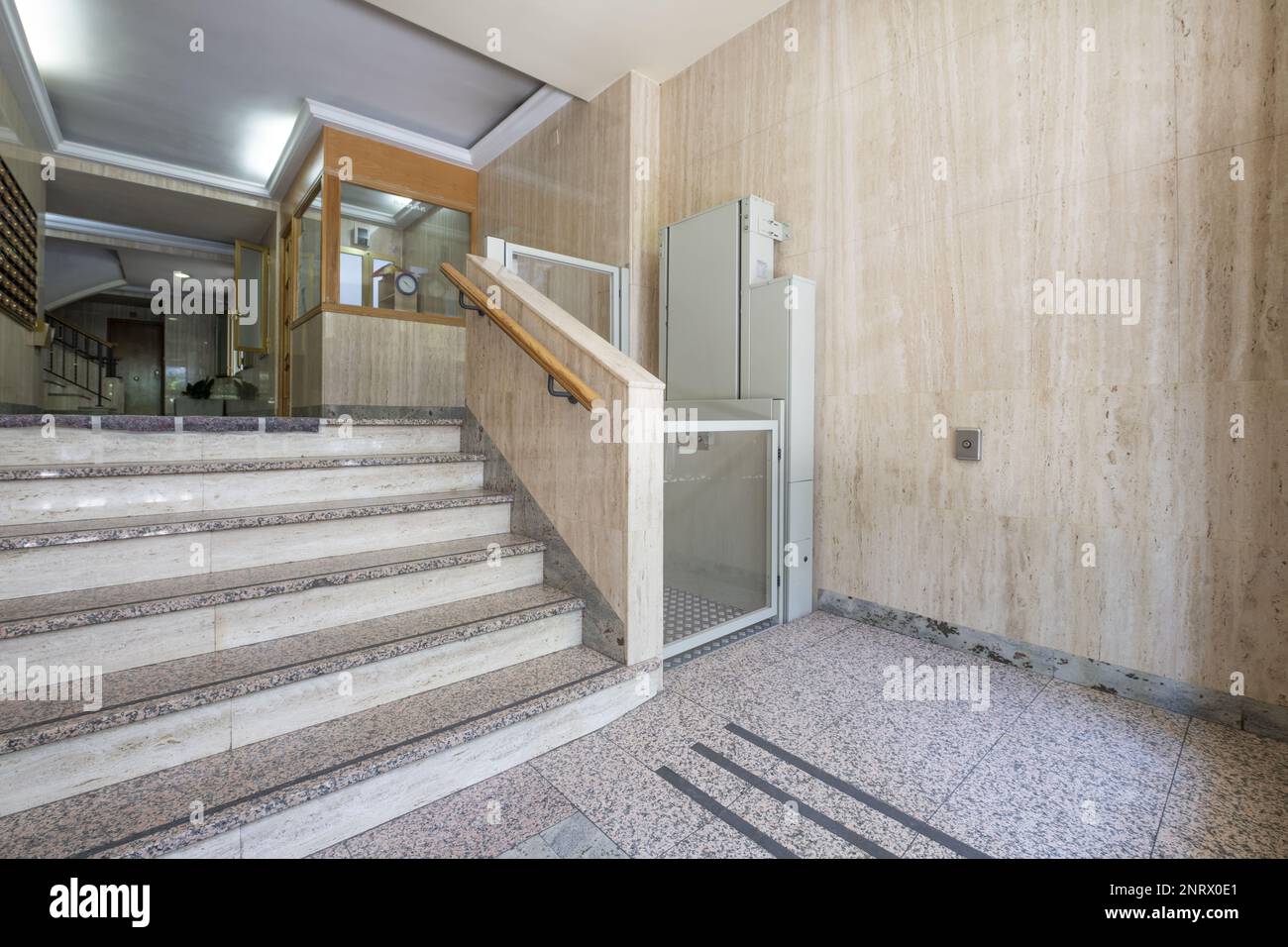 Portal of a residential building with marble stairs and a hydraulic lift for people with mobility problems Stock Photo