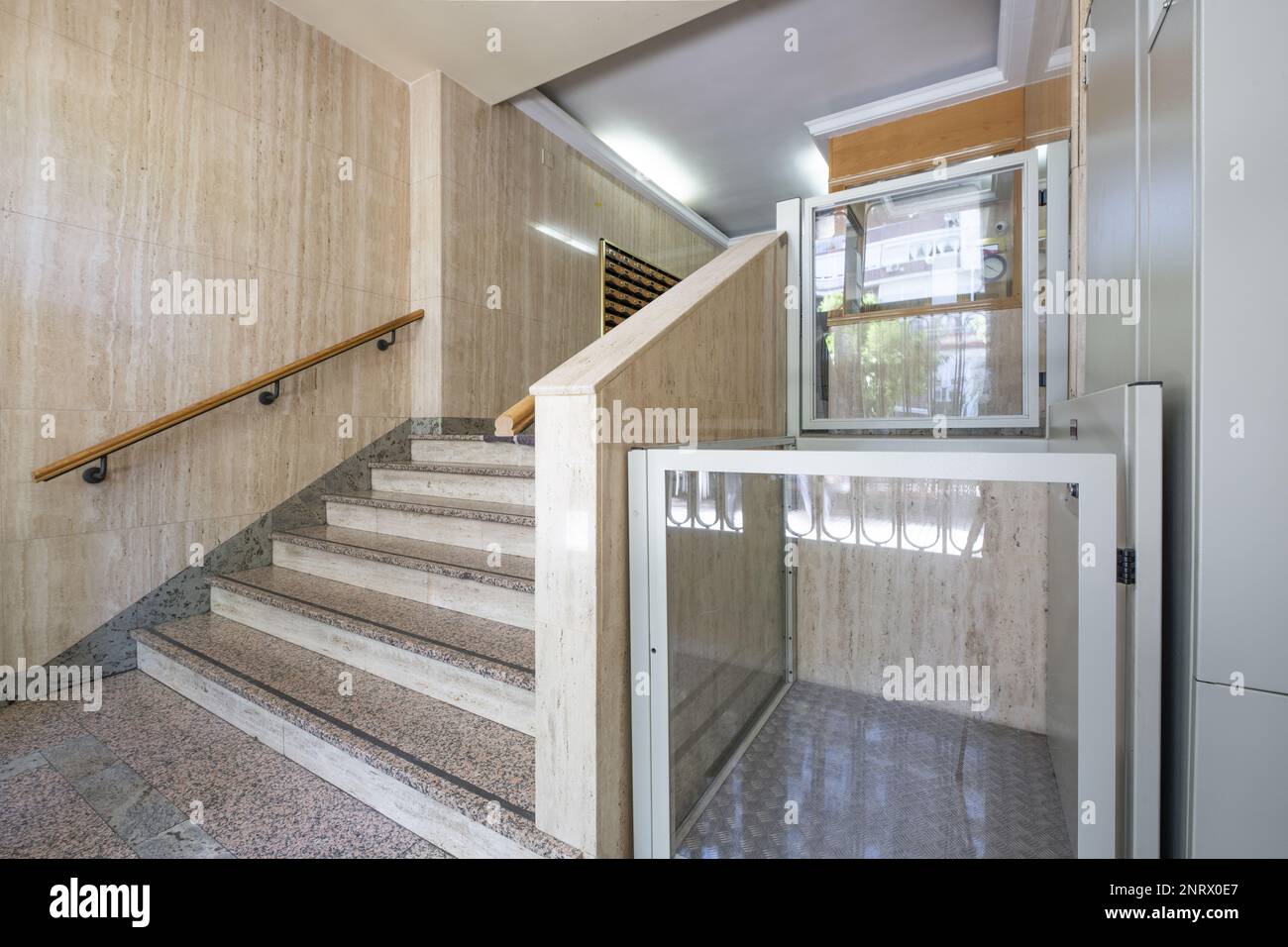 Portal of a residential building with granite stairs, marble walls and hydraulic elevator for people with mobility problems Stock Photo