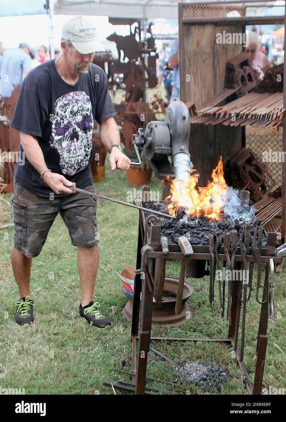 David Thomson a fire place poker at the Oakville Ironworks booth at Old Timers Day at the