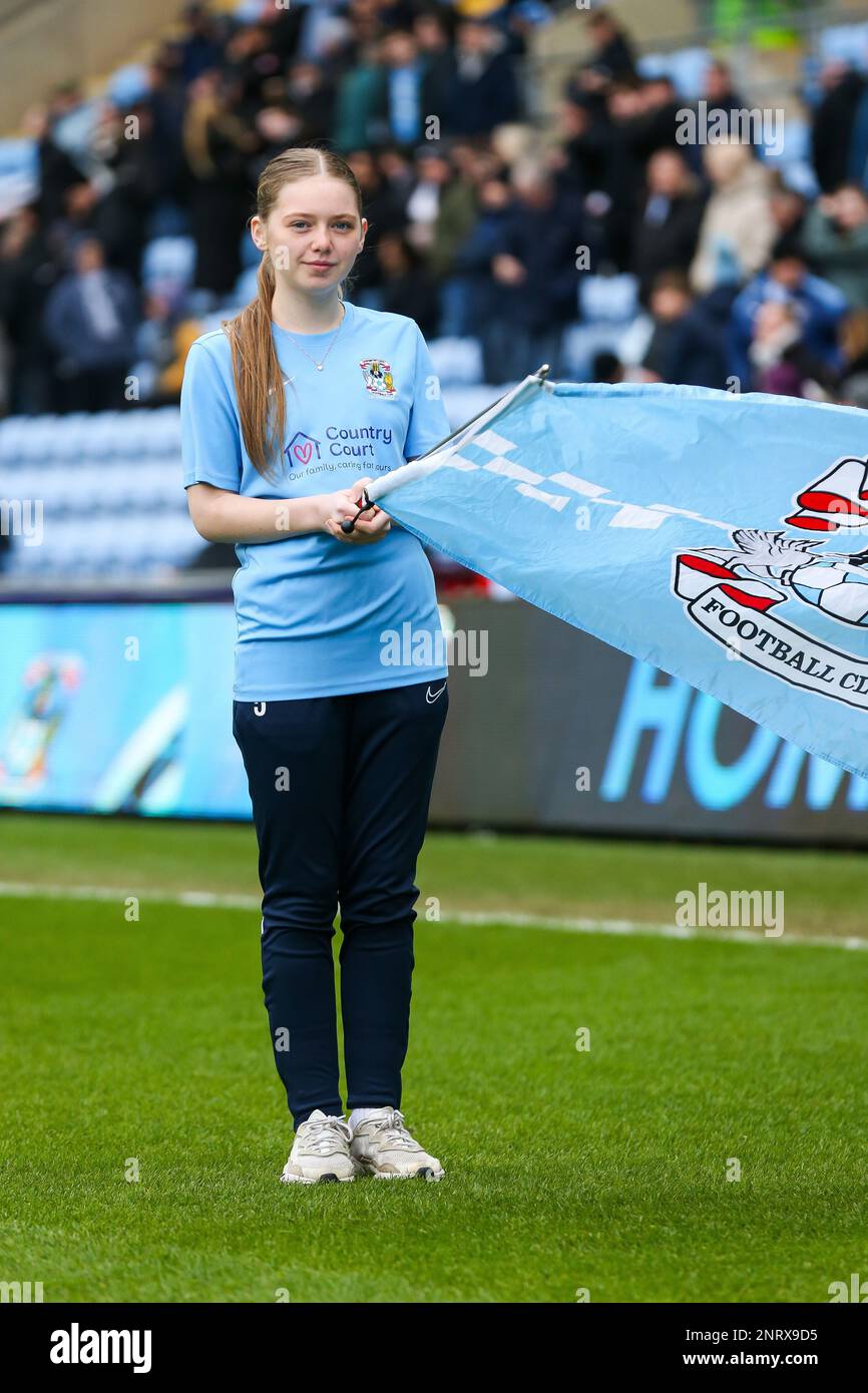 A Coventry City match day flag waver on the pitch ahead of the Sky Bet