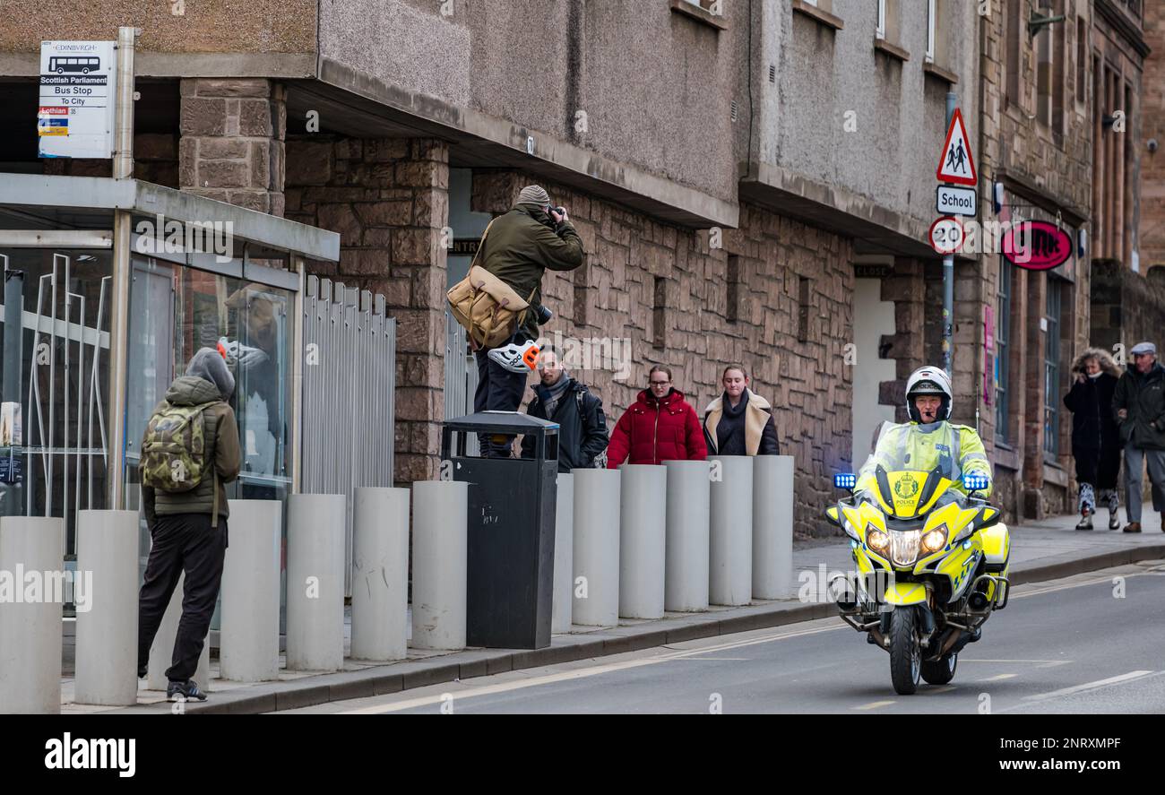 Photographer taking photo of march on Royal Mile with police motorcyclist, Edinburgh, Scotland, UK Stock Photo