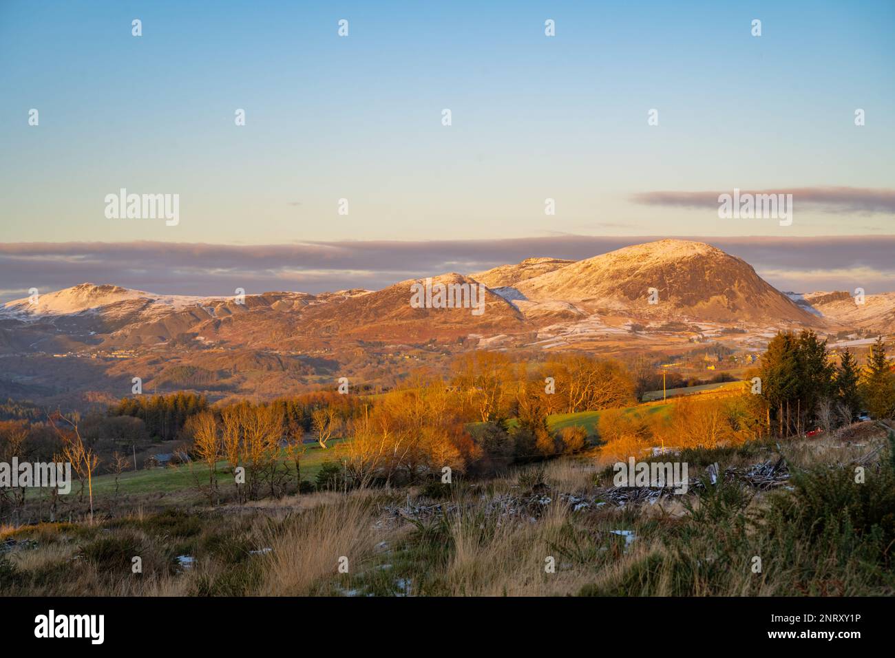 Looking towards the hills of The Vale of Ffestiniog snowdonia from country road near Gellilydan, Blaenau Ffestiniog on a late winter afternoon. Stock Photo