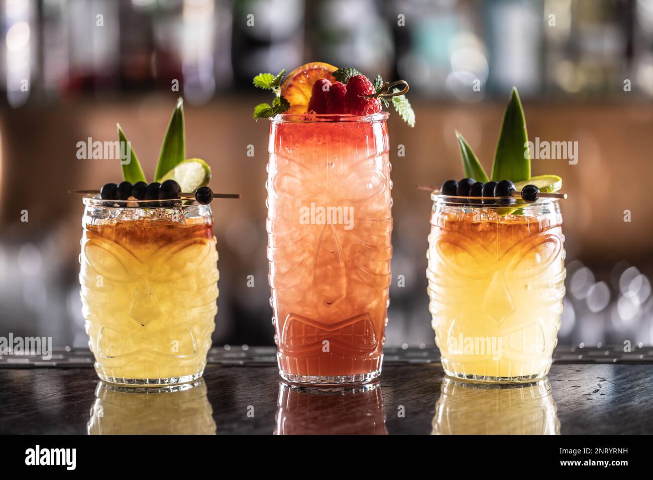 Mai tai cocktails in hawaiian glasses garnished with pineapple
