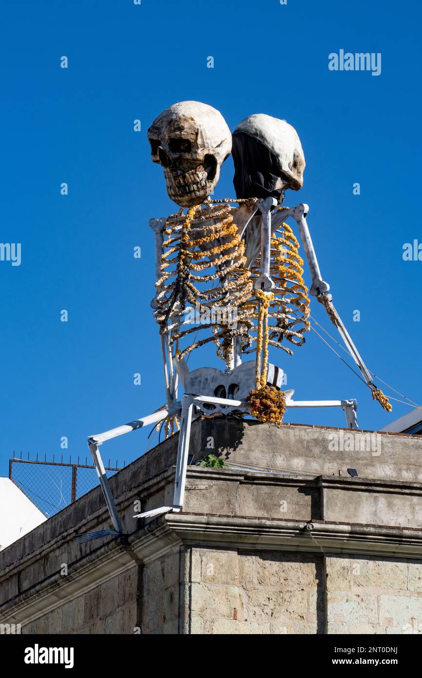 Two skeletons celebrating the Day of the Dead on a rooftop in the historic center of Oaxaca, Mexico. Stock Photo