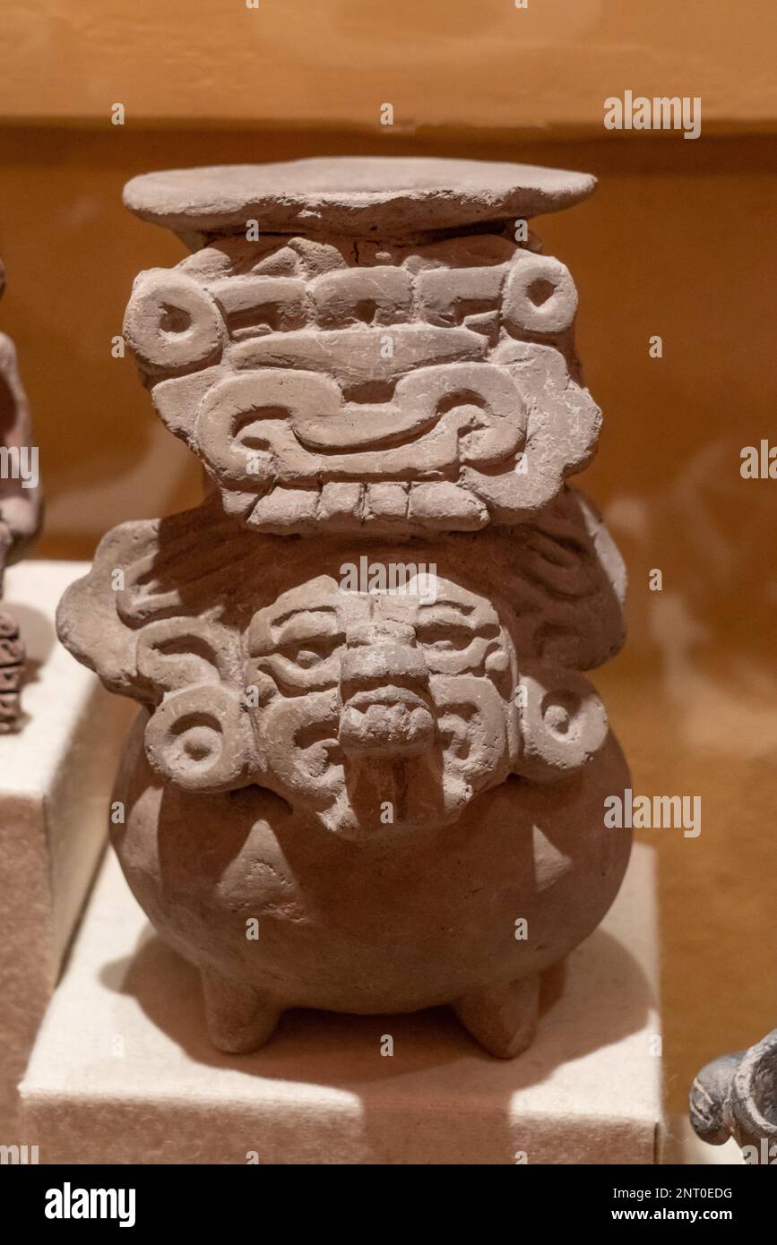 A ceramic funerary urn depicting the Zapotec rain deity Cosijo in a museum in Santiago Matatlan, Oaxaca, Mexico.  From the El Palmillo archeological s Stock Photo