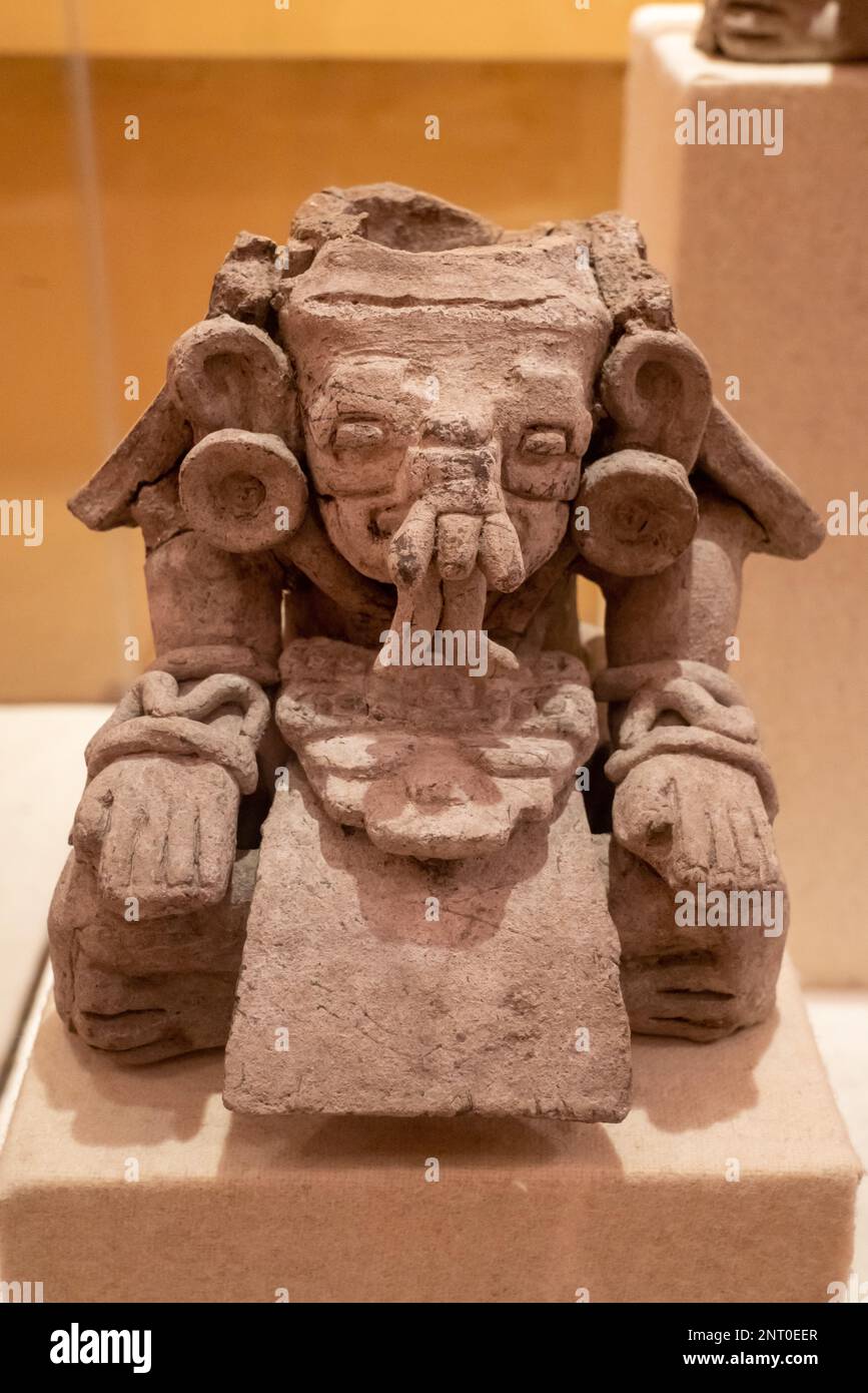 A ceramic funerary urn depicting the Zapotec rain deity Cosijo in a museum in Santiago Matatlan, Oaxaca, Mexico.  From the El Palmillo archeological s Stock Photo