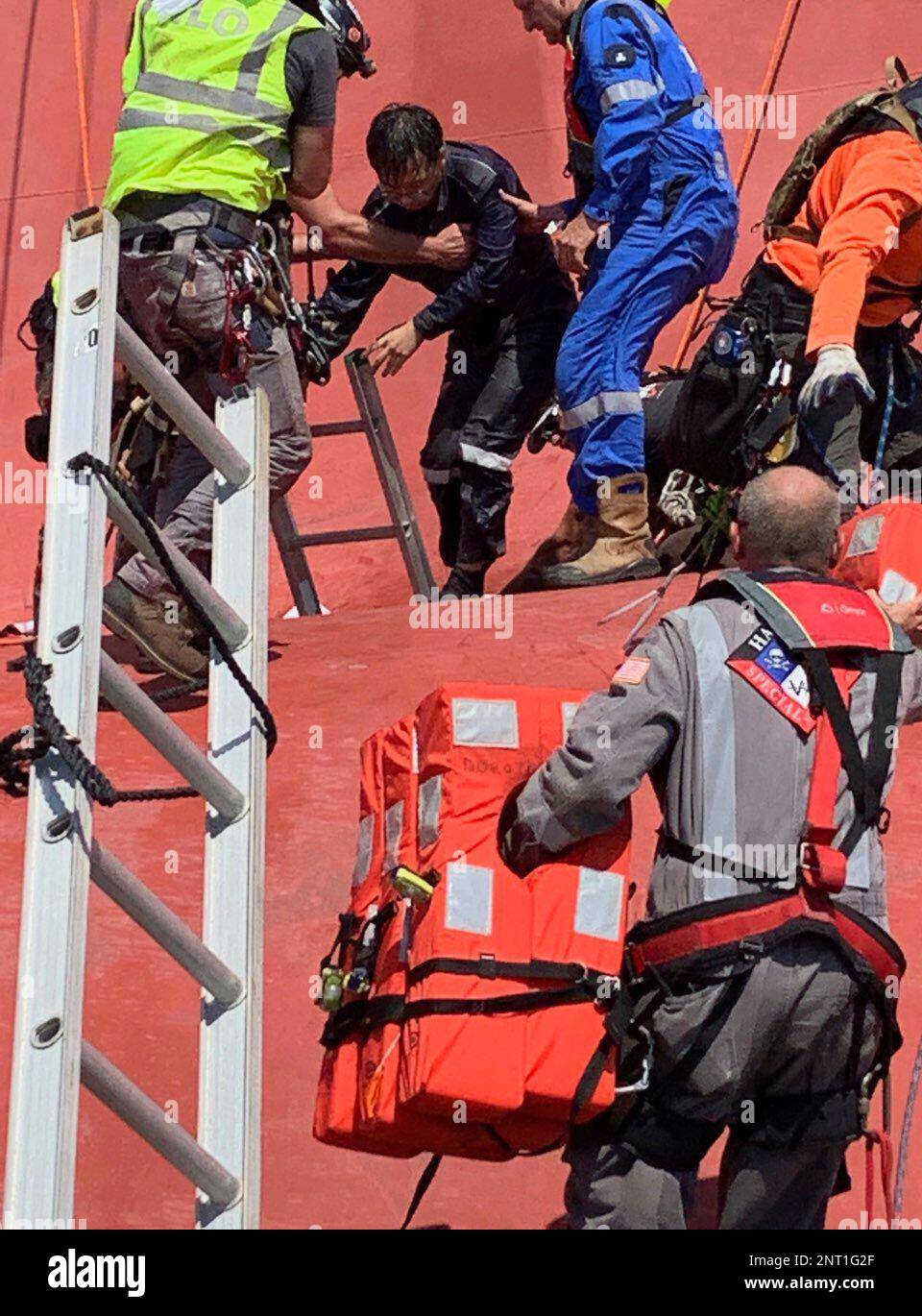 In this image released by the U.S. Coast Guard, a crew member of the