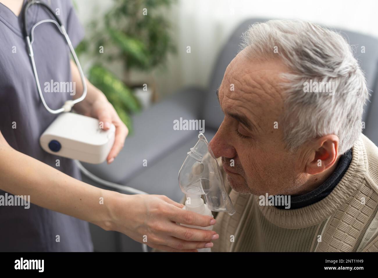 Elderly Senior Man nursing care wear oxygen inhaler device for helping