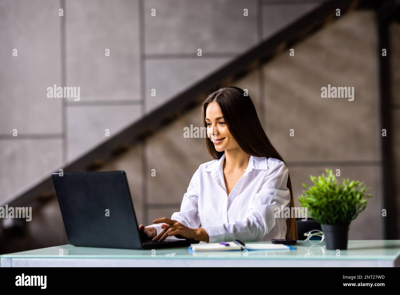 Beauitul young woman working using computer laptop concentrated and smiling Stock Photo
