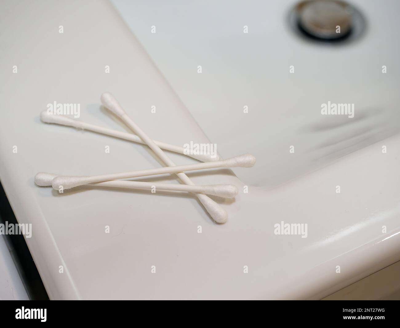 Cotton swabs in the ears on a white background Stock Photo Alamy
