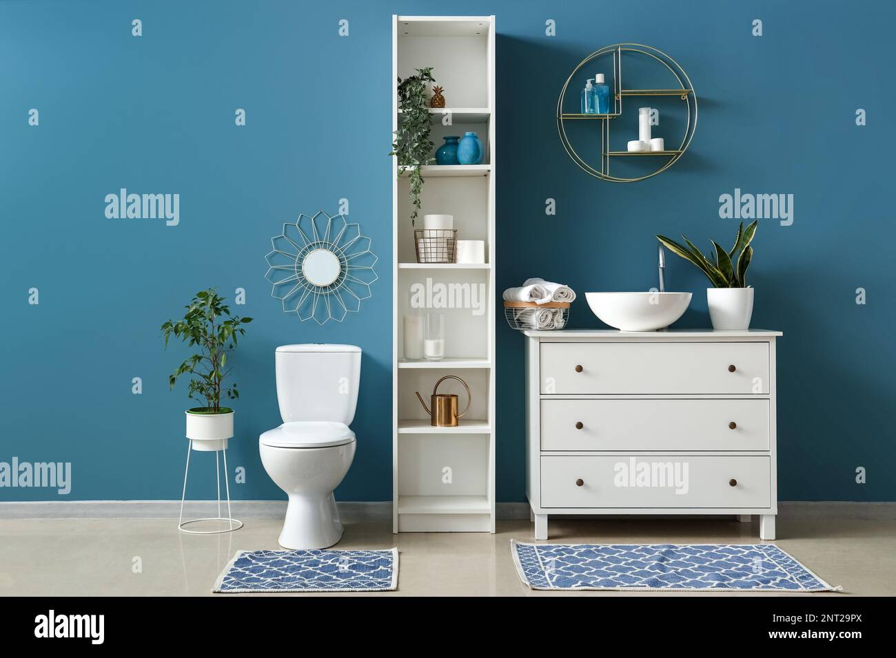 Interior of bathroom with sink, toilet bowl and shelving unit Stock ...