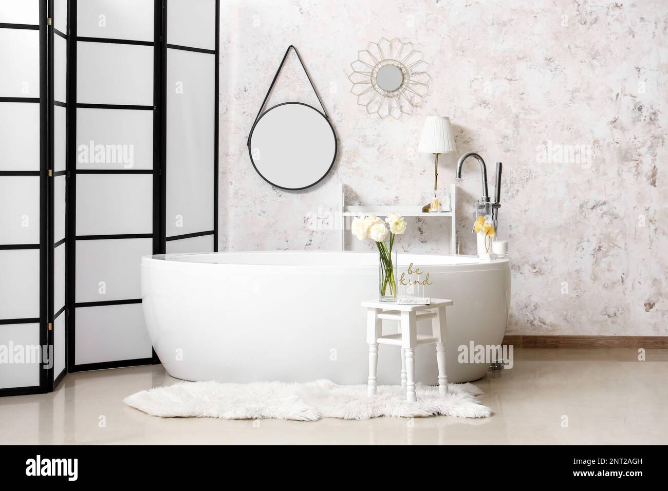 Interior of light bathroom with bathtub and mirrors Stock Photo Alamy