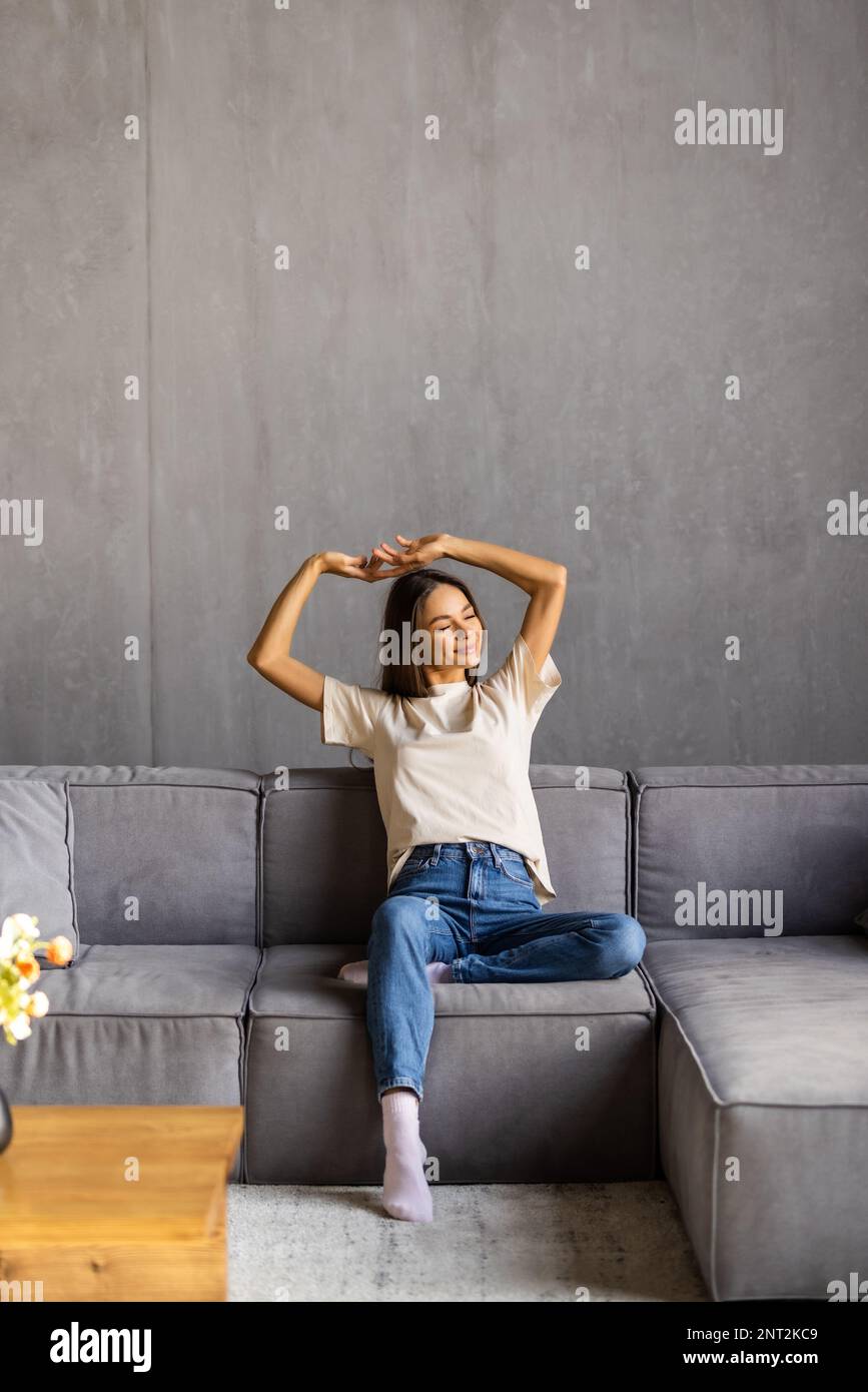 Portrait of a girl relaxing on a sofa after work at home sitting on a sofa in the living room at home Stock Photo