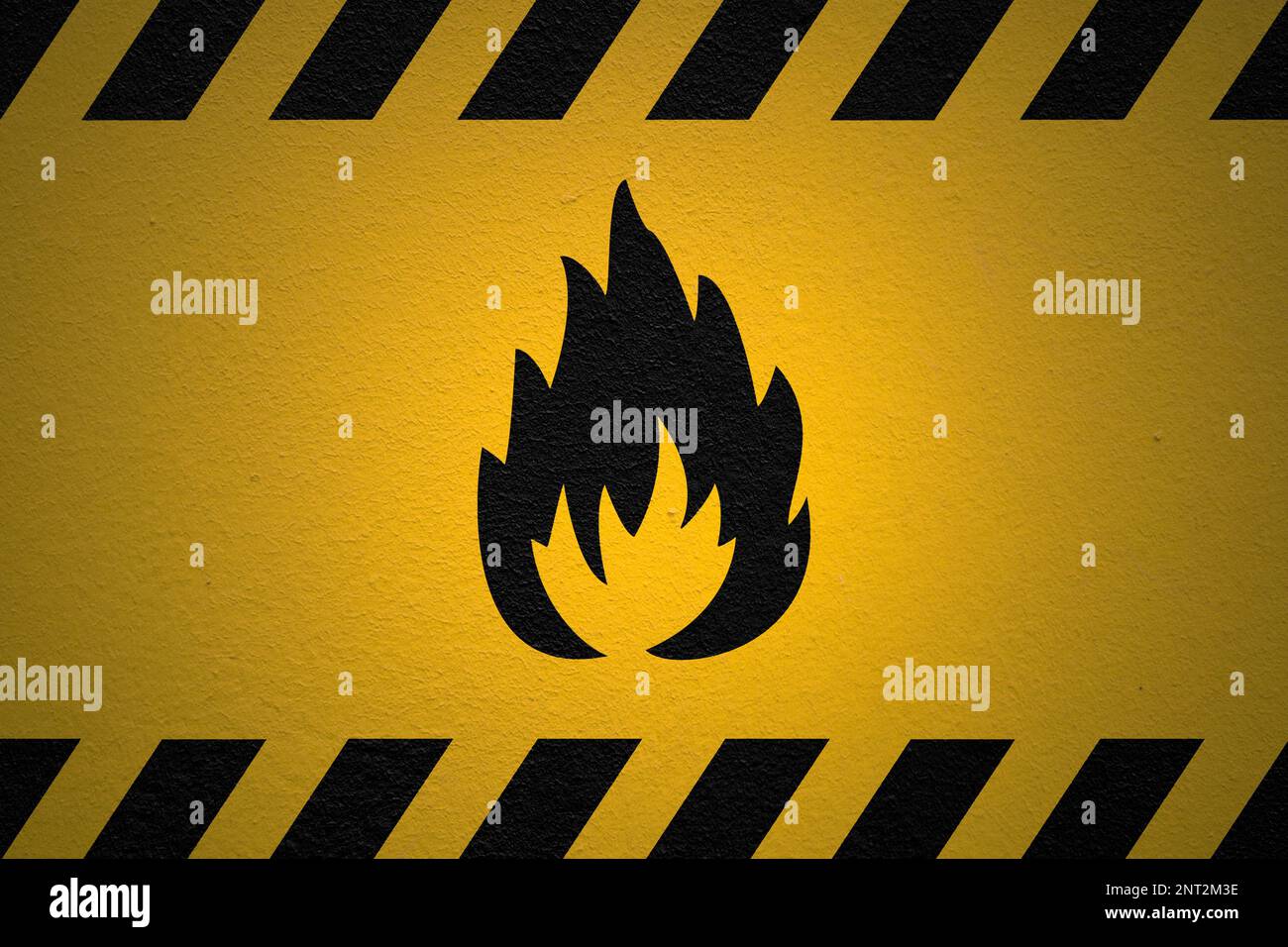 Black striped yellow background with a Danger Flammable Sign and a light effect to dramatize the whole. Stock Photo
