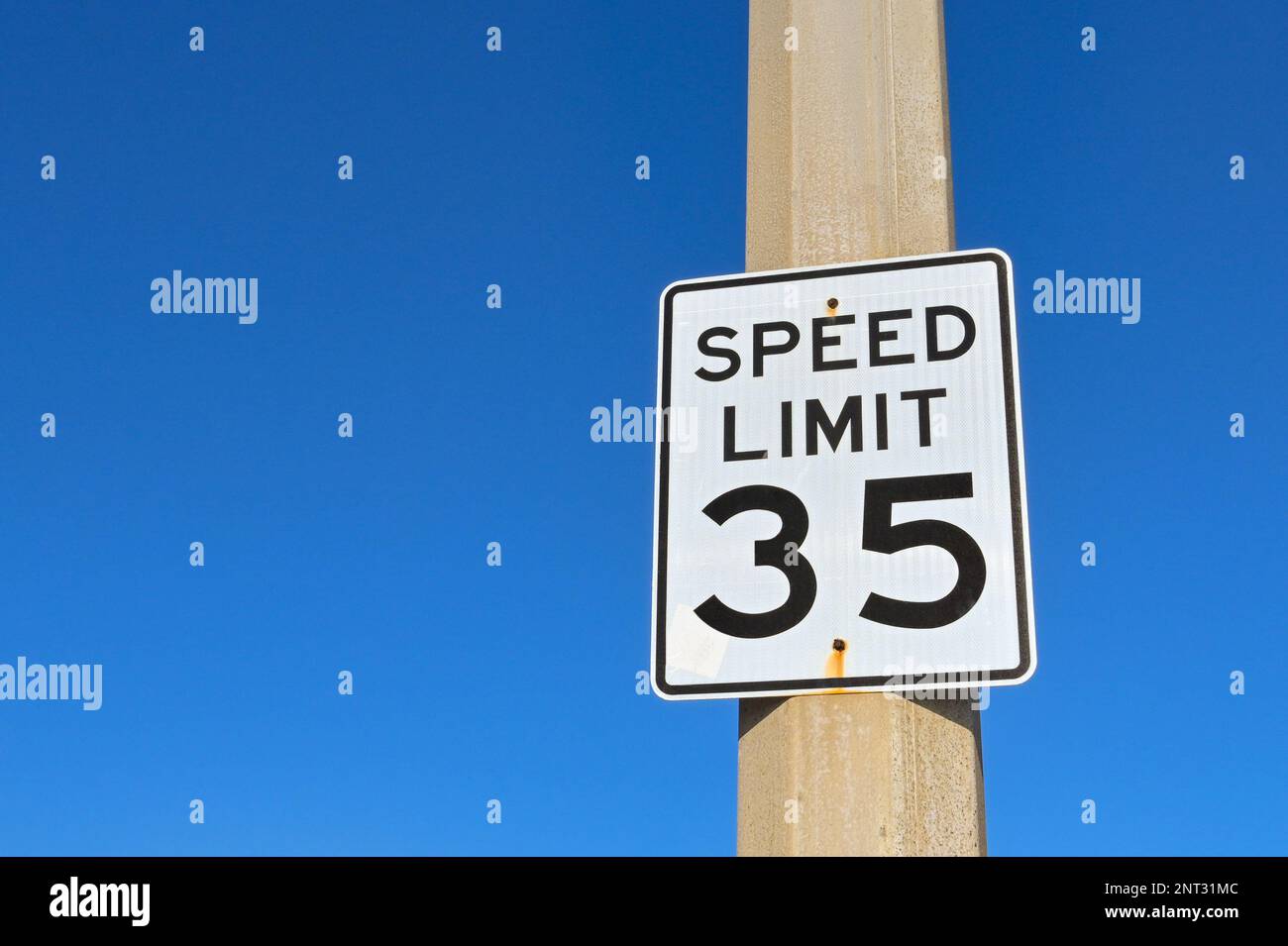 Speed limit sign in the USA isolated against a deep blue sky. No people. Copy space Stock Photo