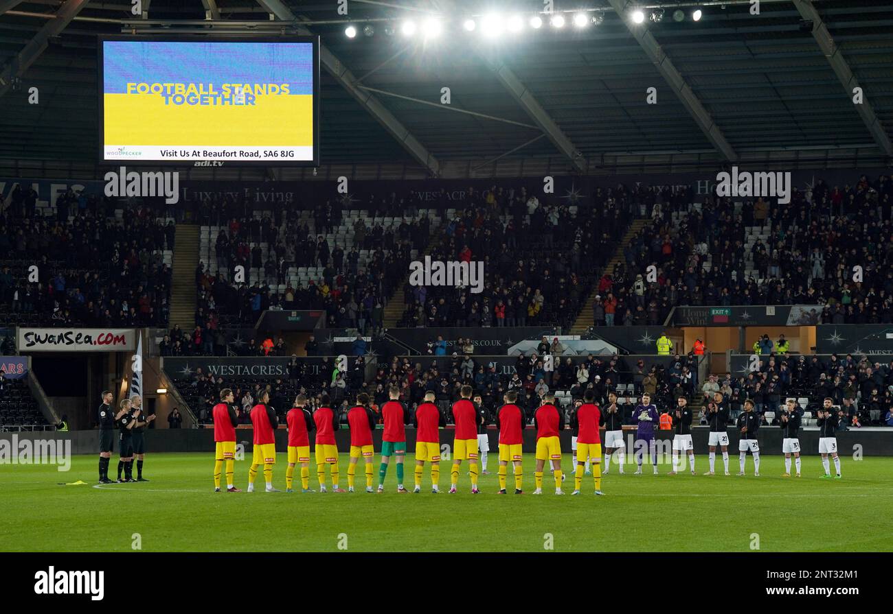 Players and fans applaud as support is shown for Ukraine on the big before the Sky Bet