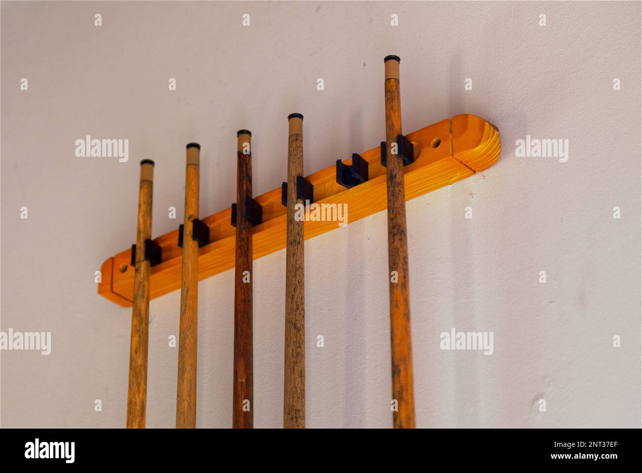 Close-up on a rack of pool cues. Stock Photo