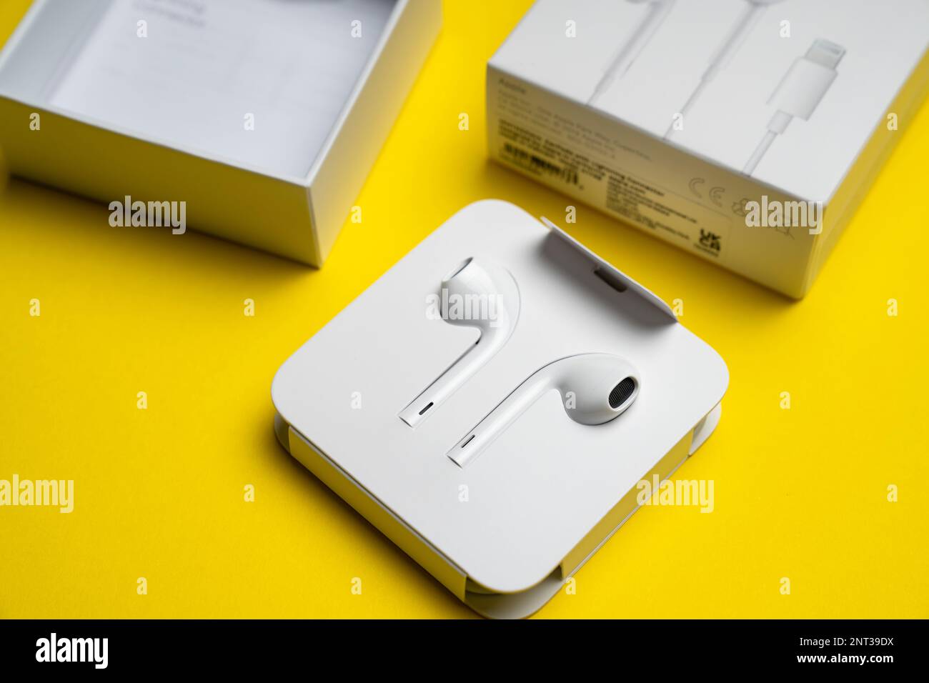 New Apple Earpods, Airpods white earphones for listening to music and  podcasts in an open box. Isolated yellow background. Budapest, Hungary -  Februar Stock Photo - Alamy