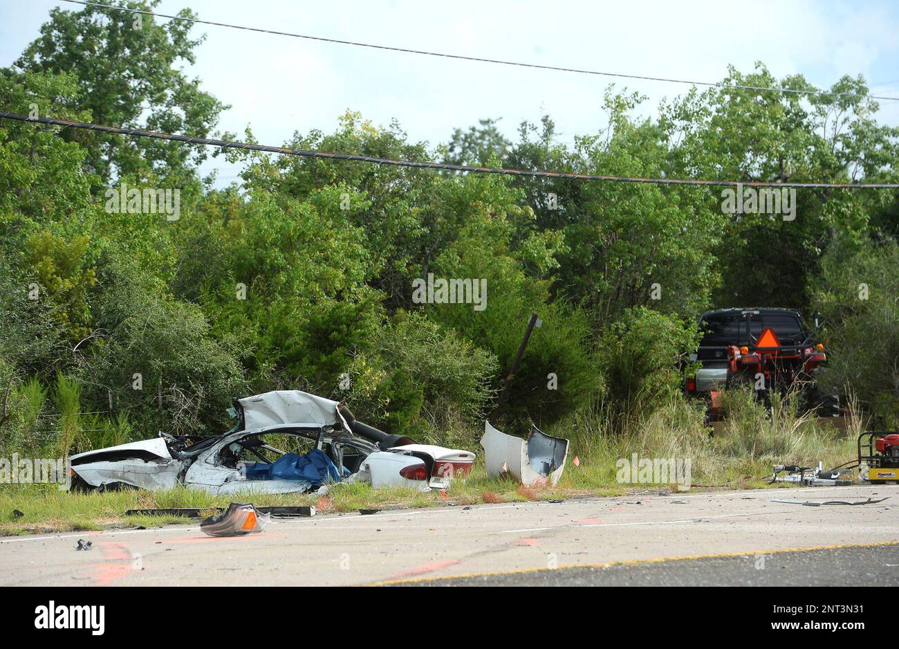 In this Friday, Aug. 23, 2019, photo, wreckage is strewn at the scene of a  fatal accident in Orange, Texas. Harley Joe Morgan and his bride, Rhiannon  Marie Boudreaux, had just been