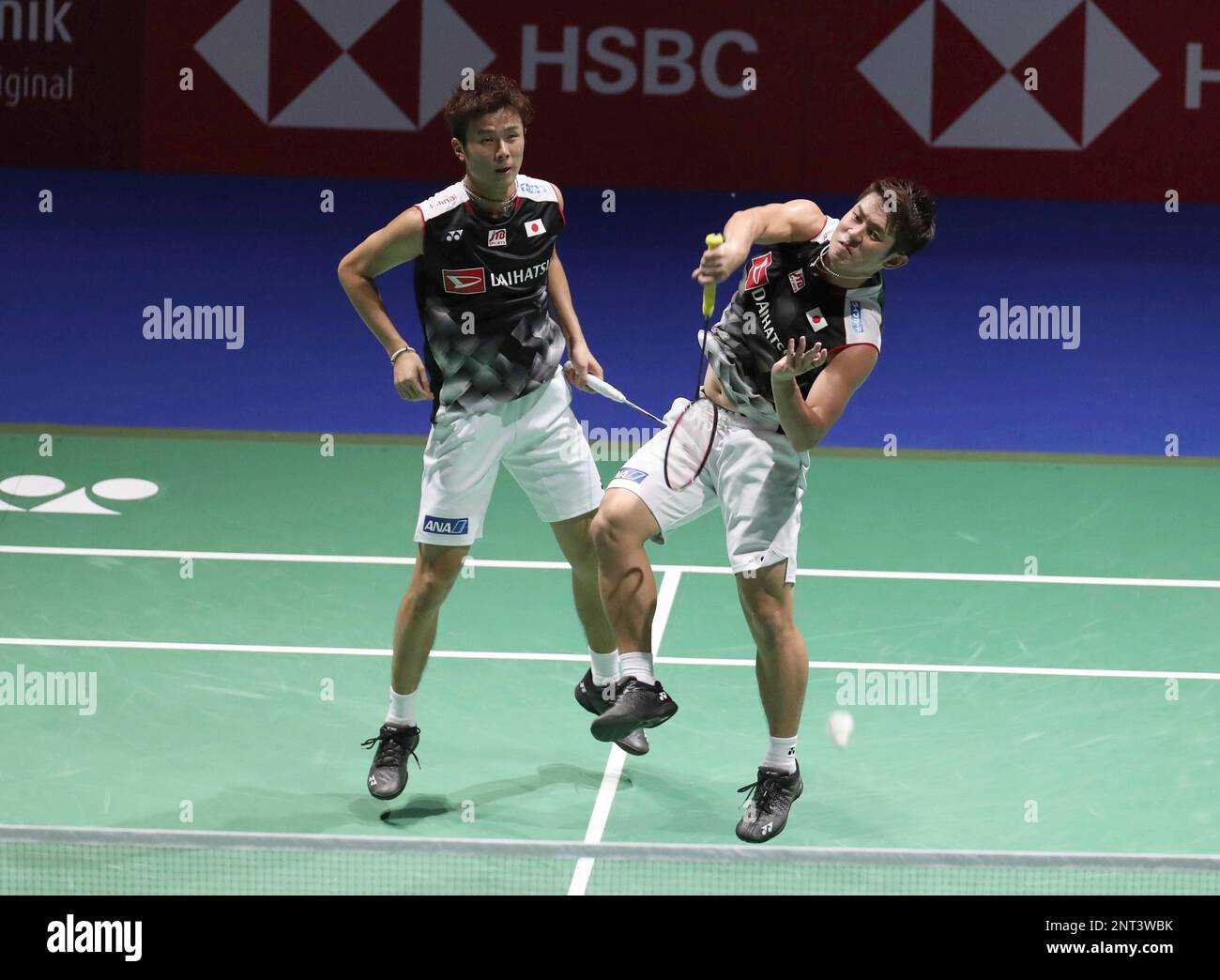 Japans Yugo Kobayashi (L) and Takuro Hoki perform during the mens doubles semifinal match against Chinese Li Junhui and Liu Yuchen at the Total BWF Badminton World Championships at St