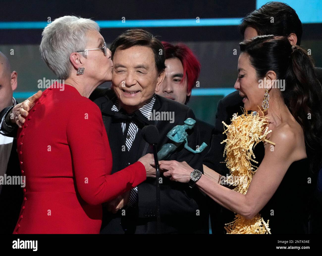 Jamie Lee Curtis, from left, James Hong, and Michelle Yeoh accept the