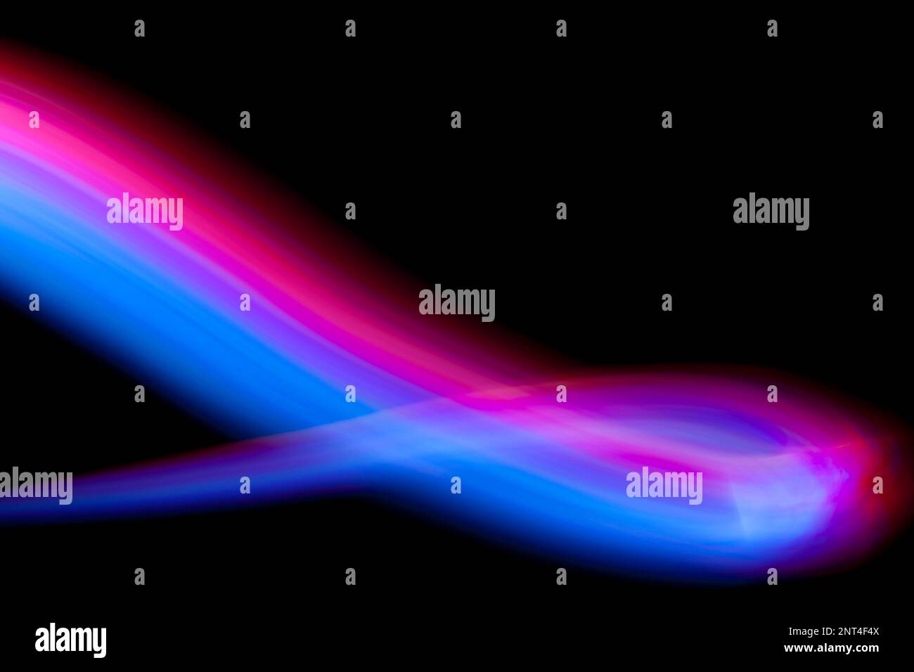 Abstract light painting forming a curve on a black background. Stock Photo