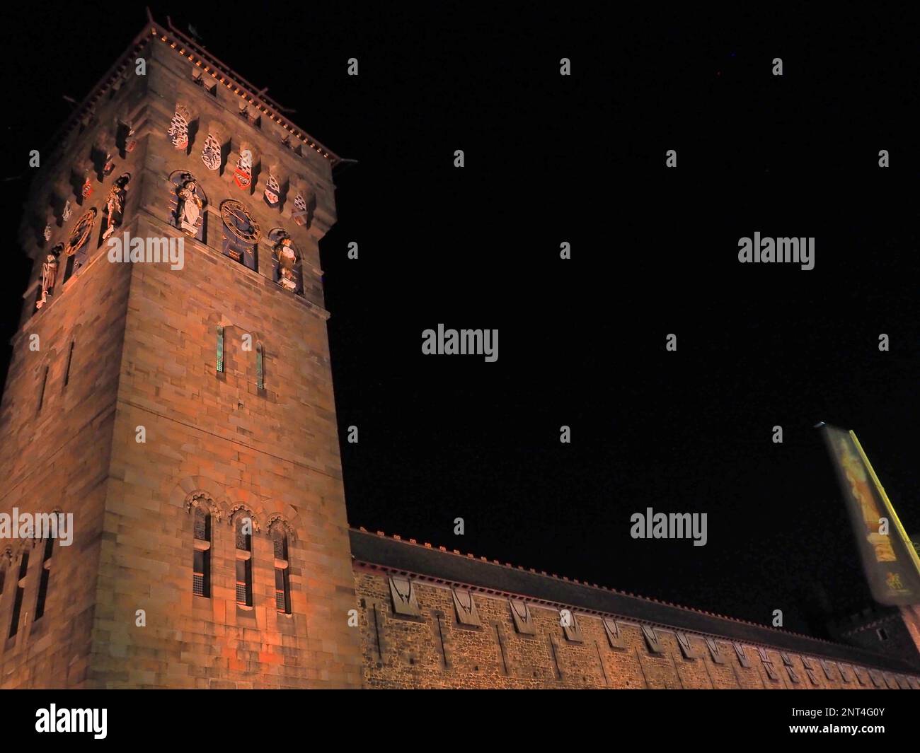 Cardiff, South Wales, United Kingdom, April 21st 2021, Cardiff Castle illuminated by an orange light in support for Acute Myeloid Leukaemia World Awar Stock Photo