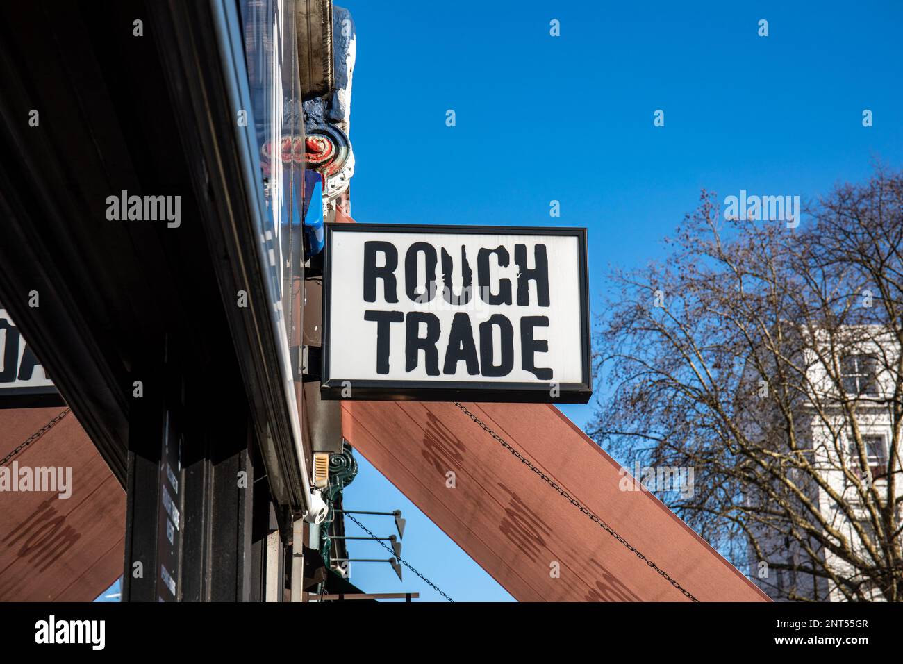 Rought Trade record shop sign against clear blue sky on 130 Talbot Road in Notting Hill district of London, England Stock Photo