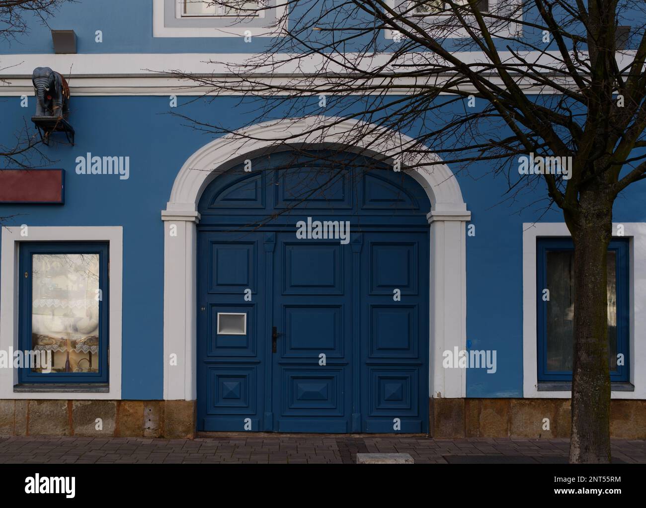 building with old blue gate and white framed window in old town Stock ...