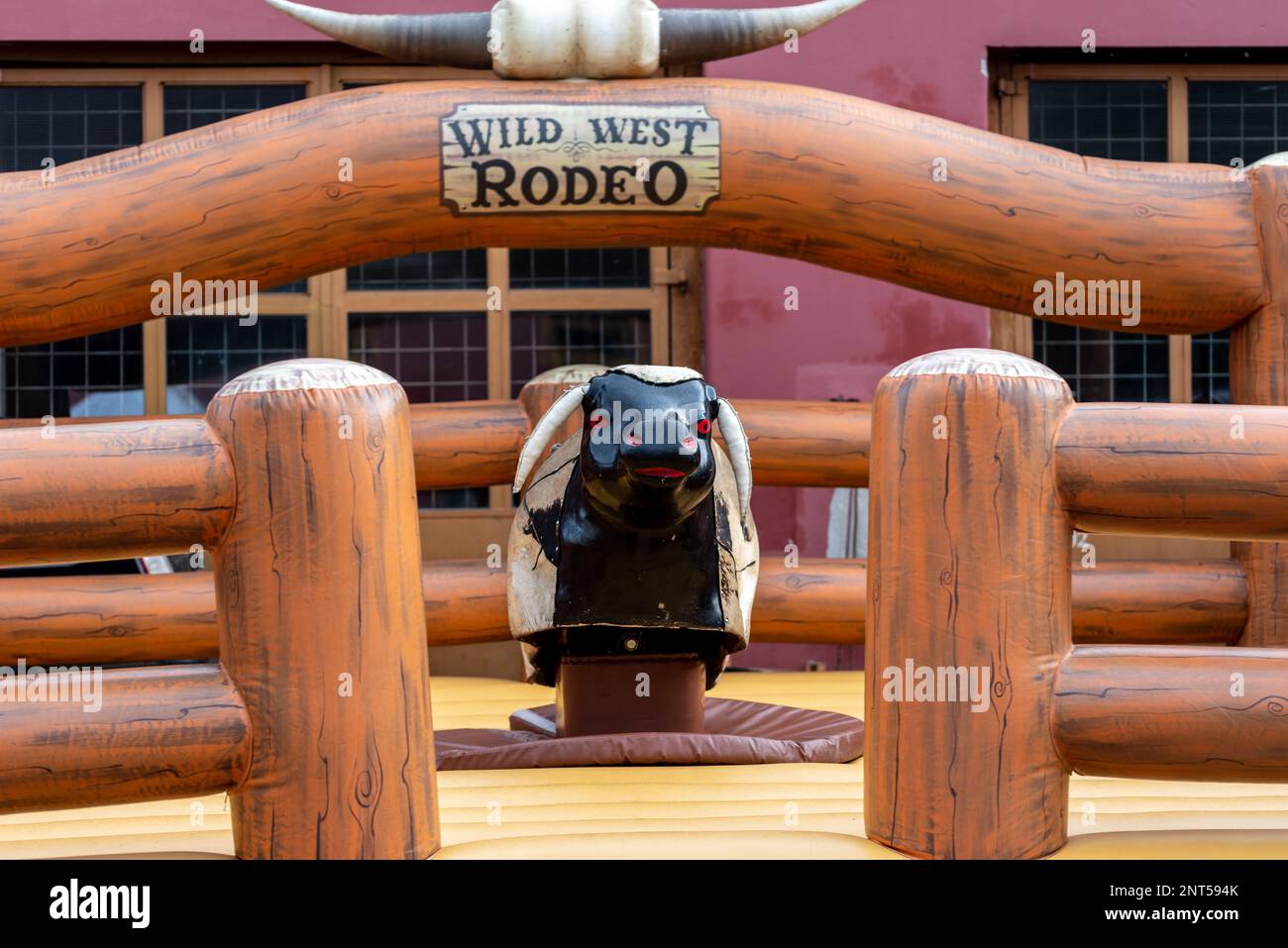 Large rodeo mechanical Bull Riding machine made from wood. Stock Photo