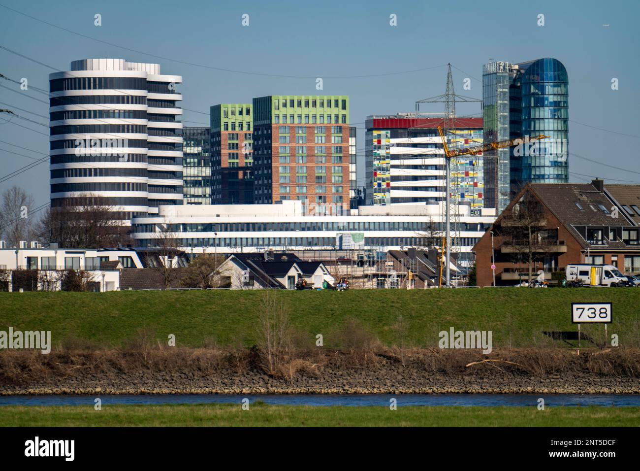 The skyline of Düsseldorf, with the high-rise buildings in the Media Harbour, in front residential buildings on the Rhine in the Hamm district, Düssel Stock Photo