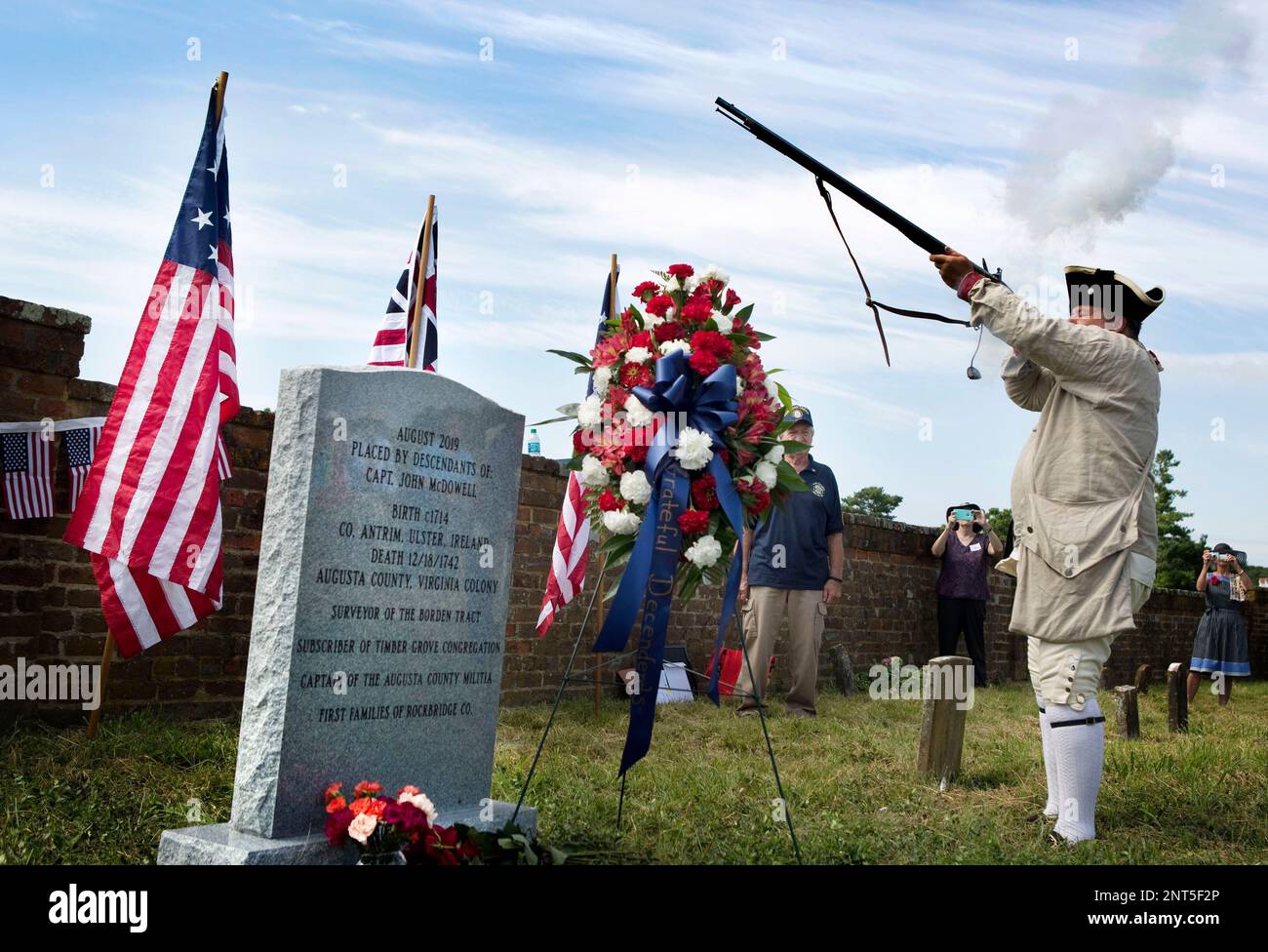 Robert J. Gang, of Syracuse, N.Y., does a threevolley rifle salute at