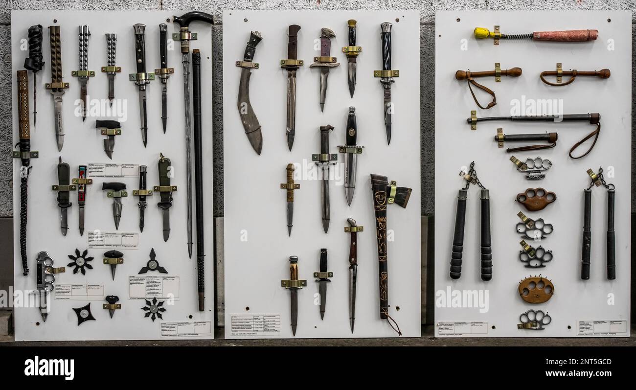 Prohibited weapons seized by the police, cutting and stabbing weapons, knives, machetes, switchblades, brass knuckles, batons, a representation of the Stock Photo