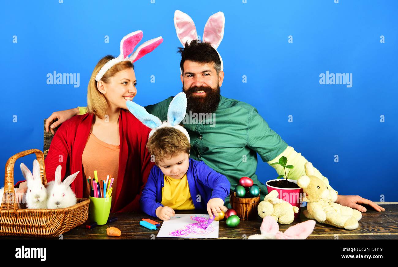 Easter family traditions. Happy parents and adorable boy in bunny ears ...