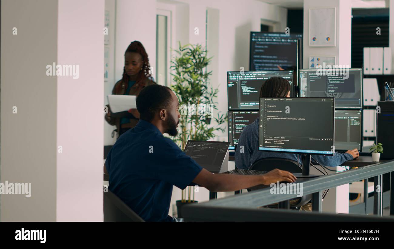 Database programer working on html script code to develop program app server with new use rinterface. Web developer typing on keyboard, computing big data on terminal window in office. Stock Photo
