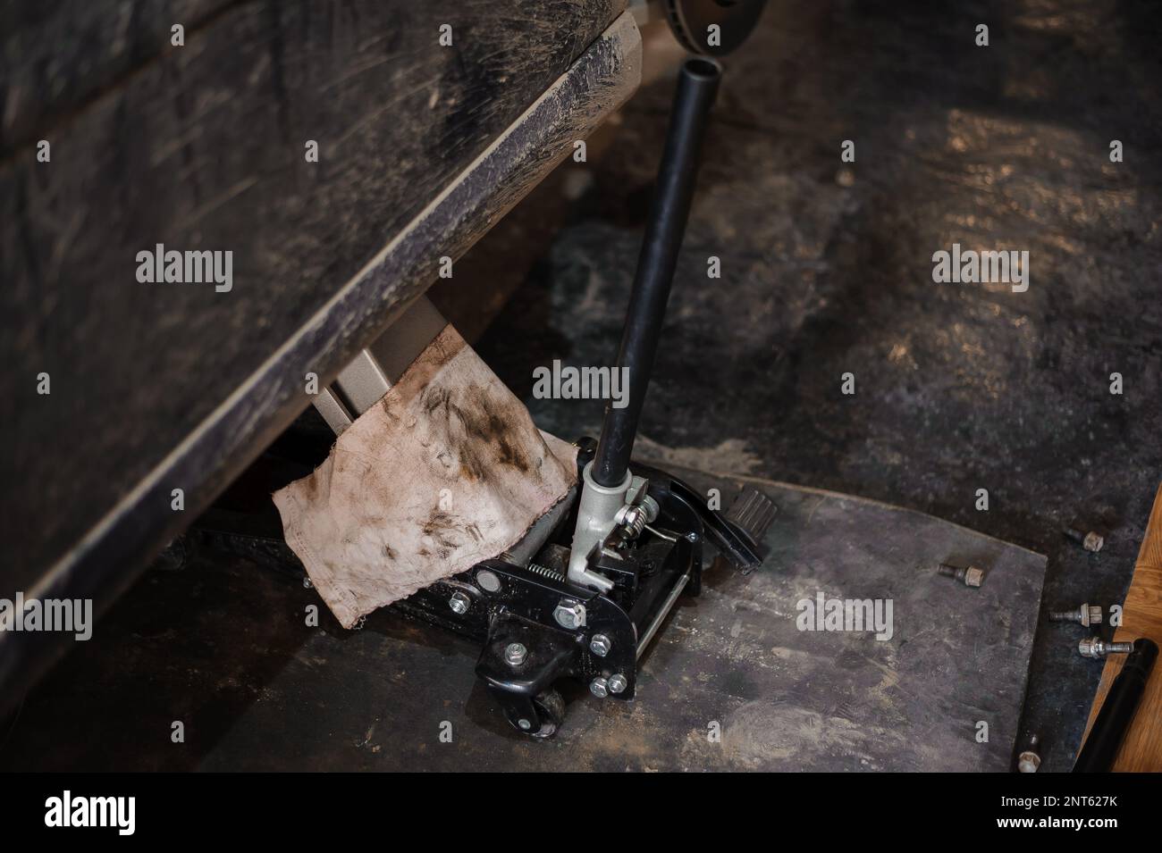 Car suspension repair. Hydraulic jack, car wheel replacement Stock