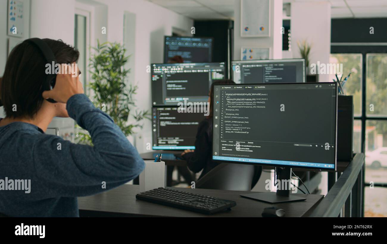 Software developer programming source code algorithm on computer, typing sever data in agency office. Database programer working on new user interface with online system to create algorithm. Stock Photo