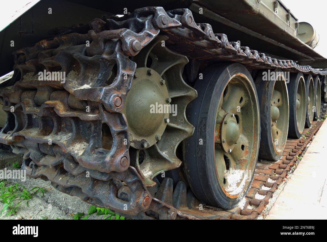 Rusty tracks of a crawler military armored carrier vehicle closeup photo for a vertical story Stock Photo