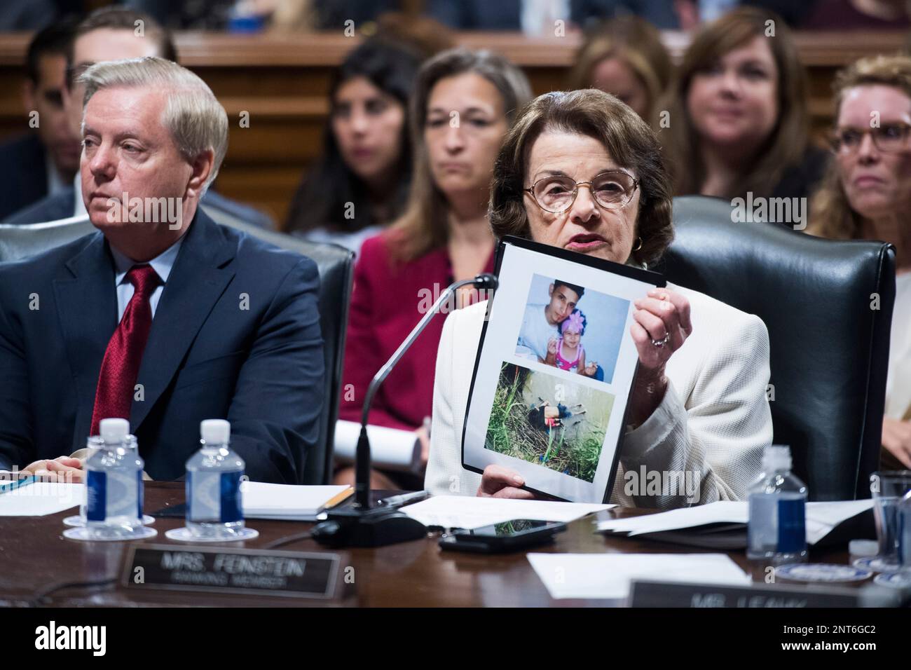 UNITED STATES - AUGUST 1: Ranking member Dianne Feinstein, D-Calif., holds a picture of Oscar Alberto Martinez Ramirez and his daughter, Valeria, as Chairman Lindsey Graham, R-S.C., looks on, during a Senate Judiciary Committee markup of the Secure and Protect Act of 2019 on August 1, 2019. The migrants from El Salvador drowned while trying to cross the Rio Grande in June. (Photo By Tom Williams/CQ Roll Call via AP Images) Stock Photo