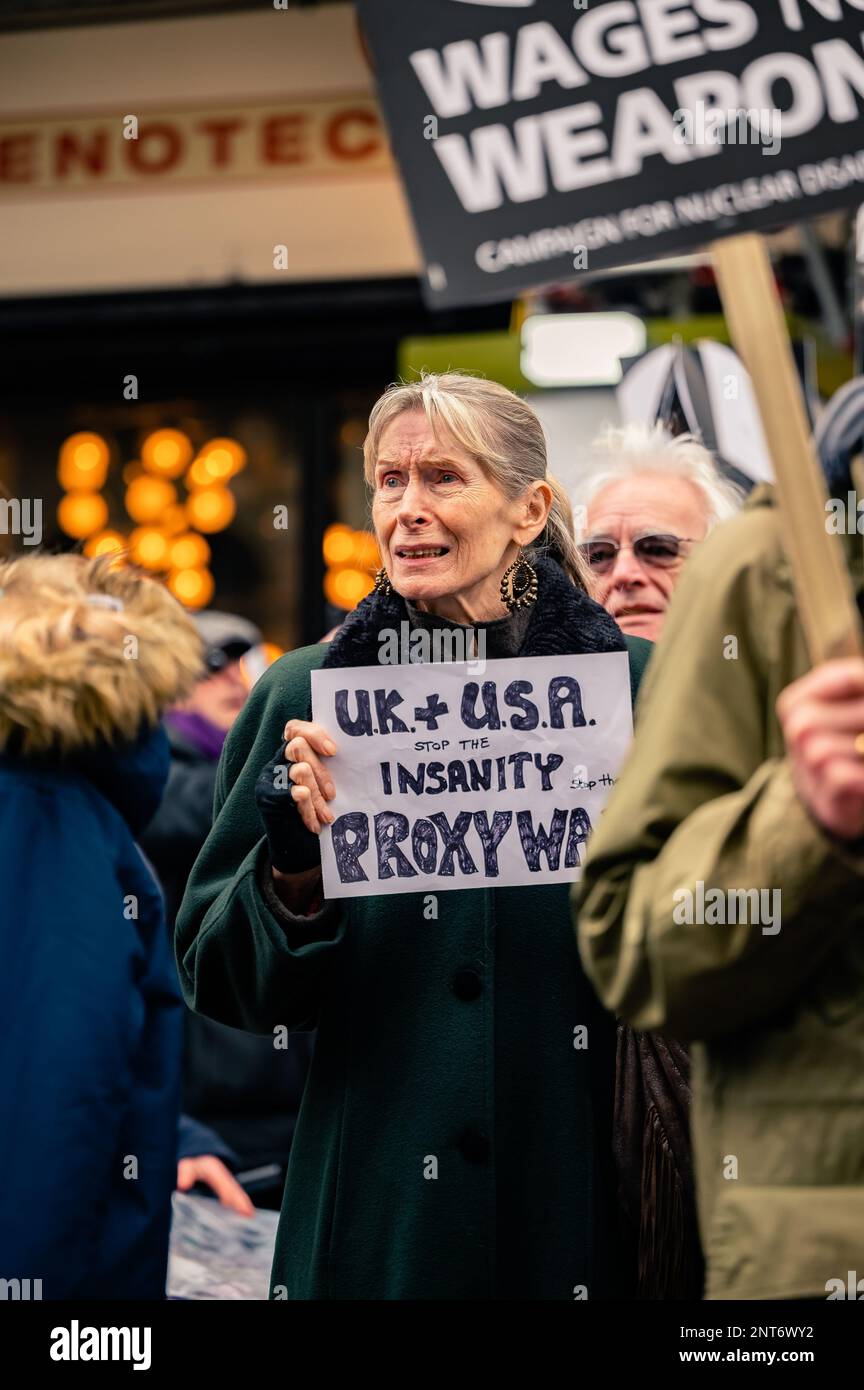 Upset woman holding an anti-war sign at the Stop The War protest in Trafalgar Square, London (February 2023). Stock Photo