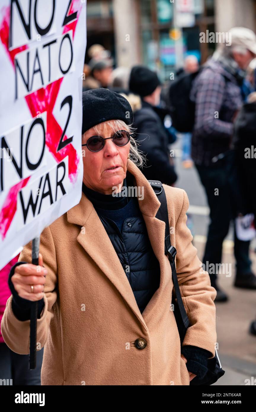 Woman holding a 'No 2 Nato, No 2 War' sign at the Stop The War march in Trafalgar Square, London (February 2023). Stock Photo