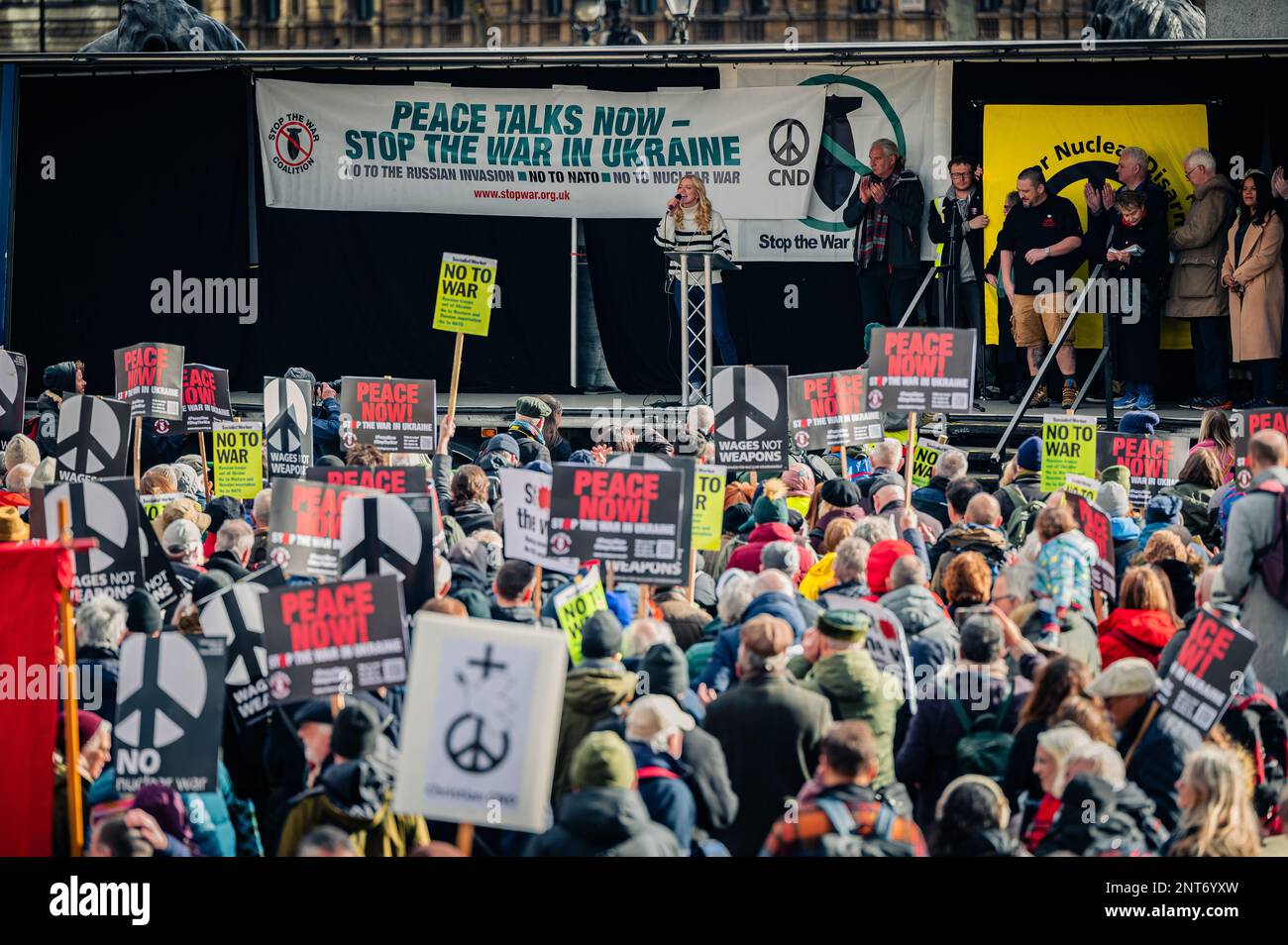 Crowd standing with signs at Stop The War protest in Trafalgar Square (London) waiting for Brian Eno to give his speech (February 2023) Stock Photo