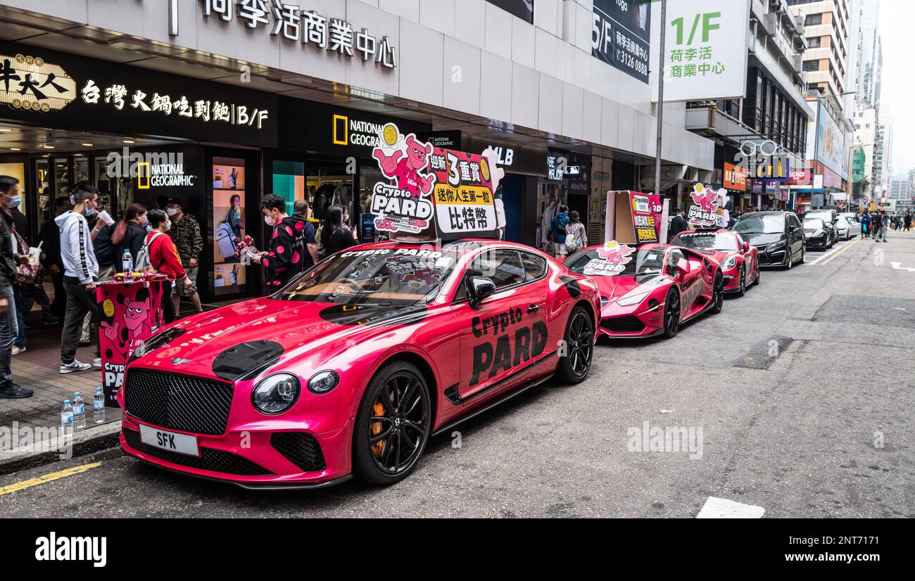 Hong Kong  Kowloon and Hong Kong island. A parade of exotic cars on a promotion tour. Bently, Lambo , and Porsche. All Pictures Neville Marriner Leica Stock Photo